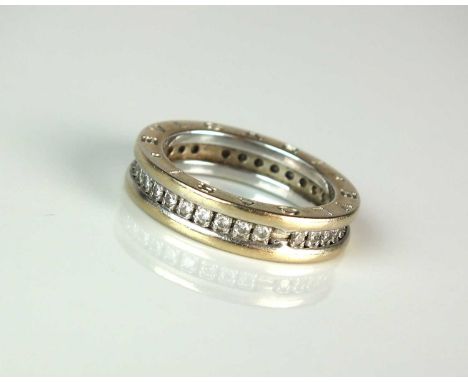 A Bvlgari B.Zero1 diamond set eternity ring, designed as a row of claw set brilliant cut diamonds within two raised bands sta