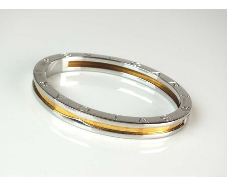 A yellow metal and stainless steel Bvlgari hinged bangle, with push fastening, stamped 'Bvlgari' 'Made in Italy' 'Steel and G