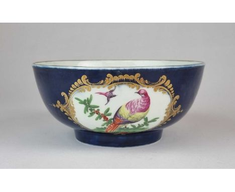 A Worcester bowl, circa 1775, painted with a pair of opposing scrolled reserve panels of fancy exotic birds against a gros bl