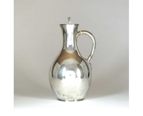 A Victorian silver lidded ewer, George Fox, London 1877, of baluster form with flat hinged cover and ivory spacers to the han