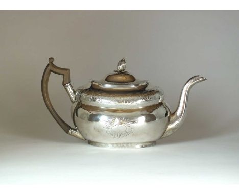 A George III Irish silver teapot, Robert Breading, Dublin 1805, of oval form with floral engraved border and crest, with wryt
