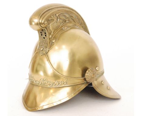 A Merryweather pattern brass fire brigade helmet with dragon embossed comb, height 24cm.    