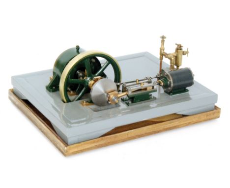 A scratch built green painted horizontal steam engine with large fly wheel and single oscillating piston, in glazed case with