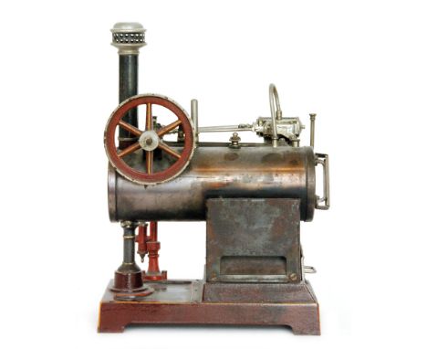 A German, possibly Marklin, spirit fired steam engine with horizontal boiler and single oscillating fly wheel, on yellow and 