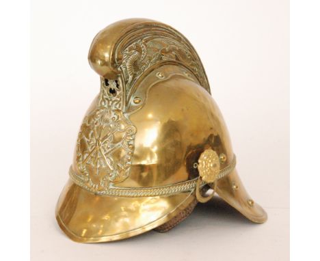 A Merryweather pattern brass fireman's helmet with crossed axe and torch badge with liner and detached chin strap, height 24c