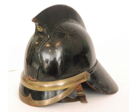 A Co-op private works fire brigade leather and brass banded helmet, established 1914 to protect factory workers at Waddens Du