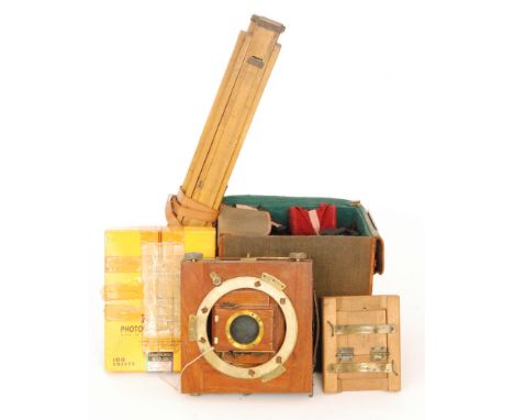 A late 19th Century mahogany half plate folding camera by Thornton Pickard together with spare plates and lens in canvas case