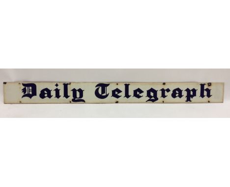 An enamel advertising sign for the Daily Telegraph, blue script lettering on a white ground, 10cm x 106.5cm.    