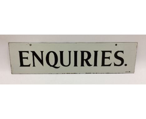 An enamel sign 'Enquiries', black lettering on a white ground, 15.5cm x 61cm.    