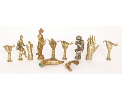 A 19th Century pipe tamper modelled as a monkey dressed as a jockey, also a seated jockey, another in the form of a dog's hea