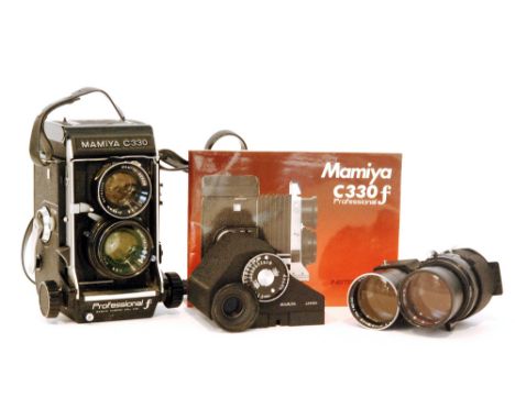 A Mamiya C330 professional F camera together with spare lenses and accessories in fitted case together with a Nikon SLR 35mm 
