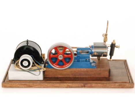 A scratch built blue painted horizontal steam engine with single oscillating fly wheel and electric motor attachment, in glaz