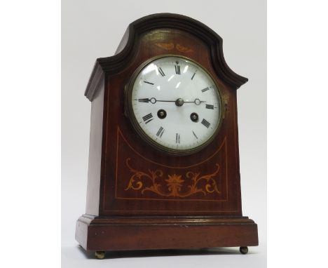 An inlaid mahogany cased mantle clock, with a white enamel dial & eight day movement, 27cm high