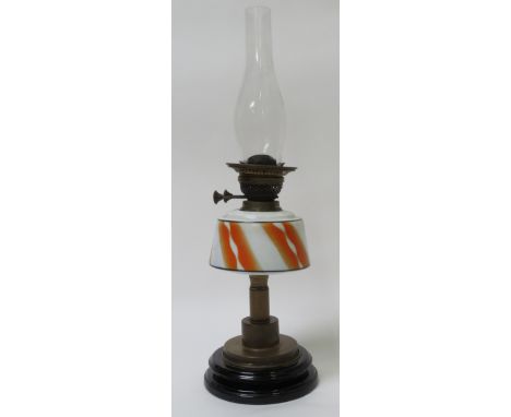 A 20th century brass lamp with a coloured glass reservoir 