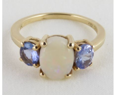 An opal & tanzanite three stone 9 carat gold ring, finger size J1/2, 2 g gross 