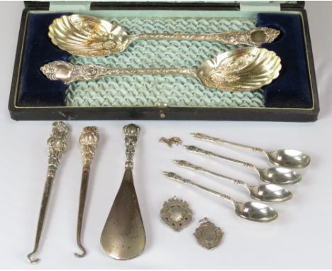 A set of four silver teaspoons with figural finials, 44 g gross; two button hooks; a shoe horn; two silver watch fobs; & a pa