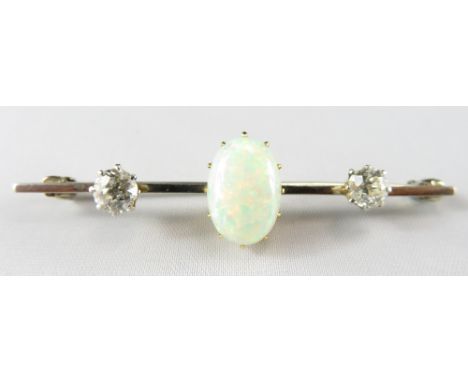 An opal & diamond three stone bar brooch, unmarked, the opal cabochon approximately 12.4 mm by 8.5 mm by 3.9 mm deep, flanked