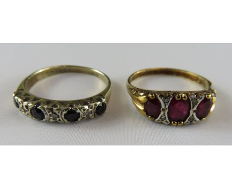 A three stone ruby 9 carat gold ring, the graduated oval cuts with pairs of small single cut diamonds in between, finger size