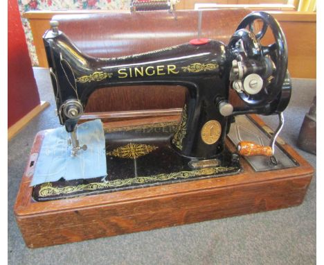A Singer manual sewing machine, cased with key 