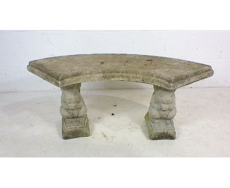 A reconstituted stone bench on squirrel supports 