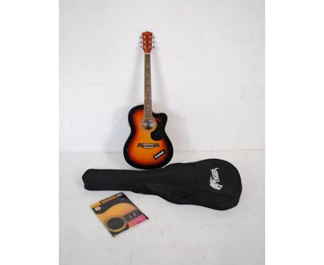 A Tiger model ACG4 electro acoustic guitar in traditional sunburst colour with soft carry case and Guitar Method Book 1