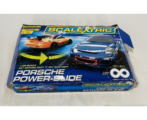 A boxed Scalextric Porsche Power-Slide set (1:32 scale), along with three additional cars