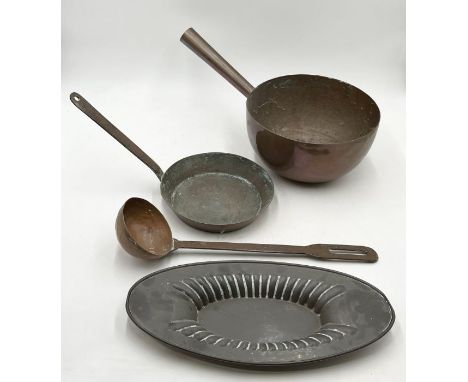 A small collection of copper comprising of two pans, a ladle and decorative tray