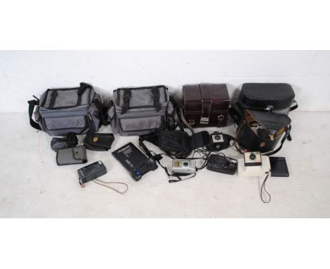 A collection of various cameras including a Swingler Model 20 Polaroid Land camera with case, Pentax Zoom 105, Rollei 70WA, P