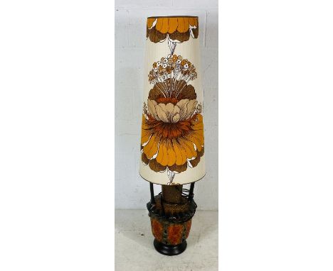 A large mid-century West German lava floor lamp with original shade featuring an orange lily.