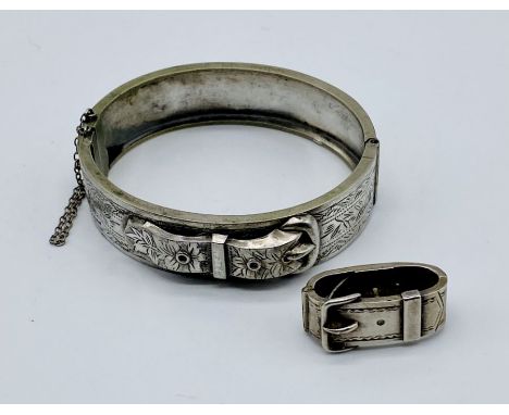 A silver hinged bangle with buckle decoration along with an SCM scarf ring also with buckle decoration