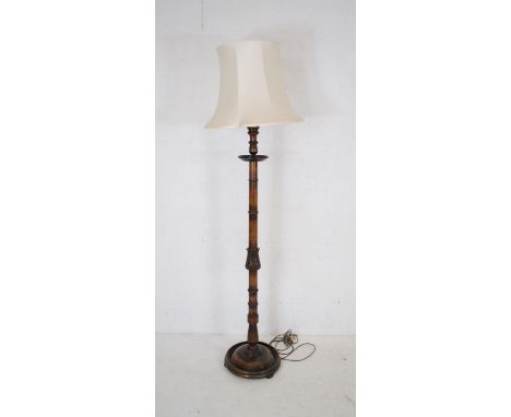 A mahogany standard lamp with carved decoration 
