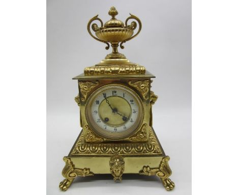 A French style gilt metal mantle clock with top acorn finial, lions head handles and enamelled chapter ring, approx. 37cm hei