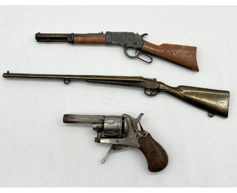A pin fired starter/dog scaring pistol along with one other and a model of a shotgun