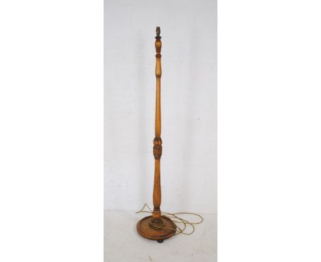 A vintage standard lamp with carved decoration