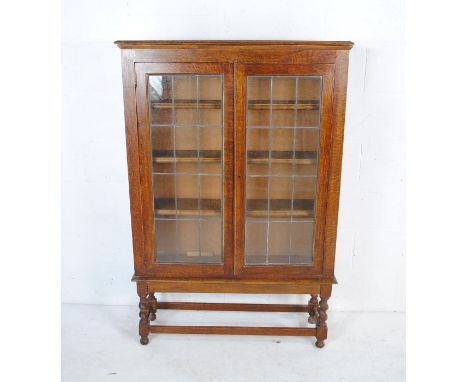 An oak display cabinet with leaded light glazing and barley twist supports - length 91cm, depth 26cm, height 138cm