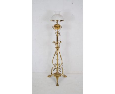 An antique floorstanding oil lamp on ornate brass stand with claw feet - height 162cm