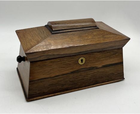 A 19th century sarcophagus shaped rosewood tea caddy with glass mixing bowl and two interior boxes