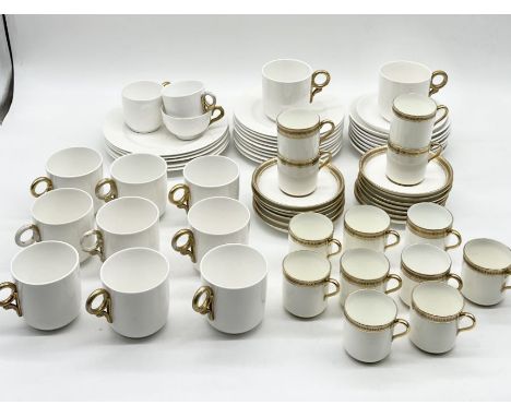 A Royal Worcester part tea/coffee set in white with gilt handles along with a Royal Cauldon part coffee set with Greek key gi