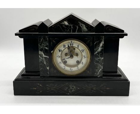 A slate mantle clock with enamel dial