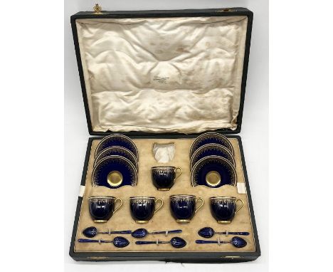 A cased Royal Worcester cobalt blue and gilt highlighted coffee set comprising five cups and six saucers with six blue enamel