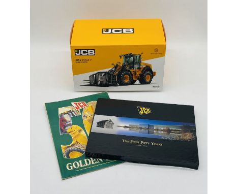 A boxed JCB 435S Stage V Wheel loader die-cast model, along with two JCB books
