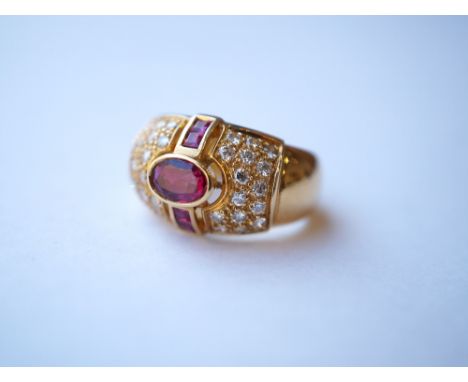 RUBY AND DIAMOND COCKTAIL RING
the central oval cut ruby in multi diamond and ruby surround, in eighteen carat gold, ring siz