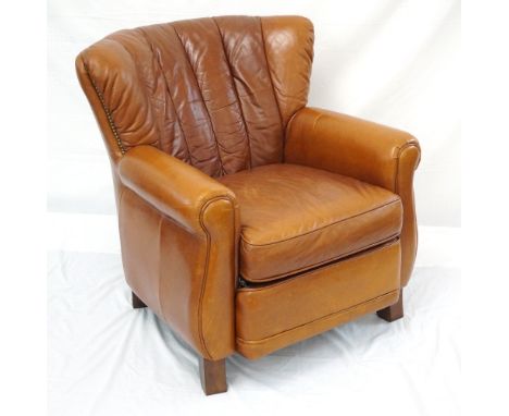 TAN LEATHER ARMCHAIR
with studwork detail, raised on short shaped supports, and a leather pouffe raised on bun feet (2) 