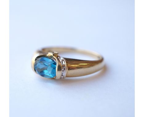 BLUE TOPAZ AND DIAMOND DRESS RING
the tension set oval cut blue topaz flanked by diamond set shoulders, on nine carat gold sh