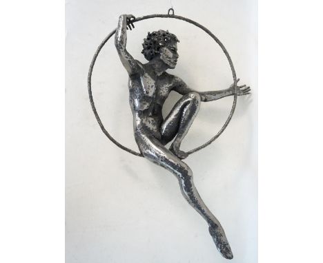 METALWORK SCULPTURE OF A NUDE BOY BALANCING IN A RING
stamped 'RI', with suspension loop, 54cm high