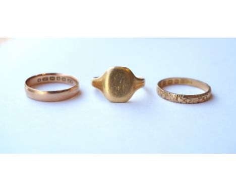 TWO VICTORIAN EIGHTEEN CARAT GOLD RINGS
one with floral decoration, and a later eighteen carat gold signet ring, all ring siz