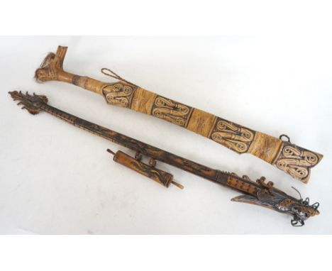 BORNEO DAYAK KNIFE
with a carved shaped handle and a shaped pierced blade, 50cm long, contained in a wood scabbard, together 