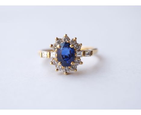 SAPPHIRE AND DIAMOND CLUSTER RING
the oval cut sapphire approximately 1.25cts in ten diamond surround with further diamonds t