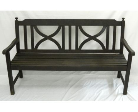 STAINED TEAK GARDEN BENCH
with a slatted seat below a back with geometric panels, 152cm wide 