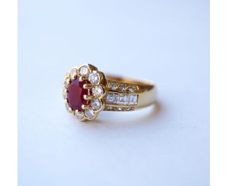 RUBY AND DIAMOND CLUSTER RING
the central oval cut ruby approximately 0.75cts in diamond surround and with further diamonds t